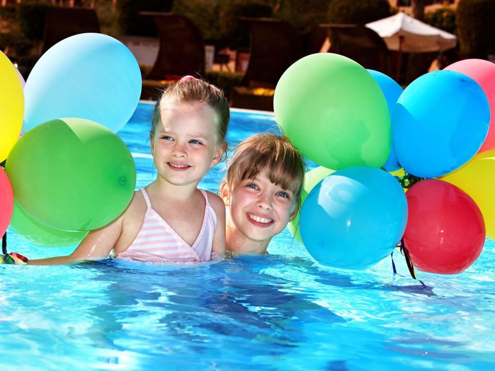 Kids playing in the pool with balloons at Grand Coloane Resort