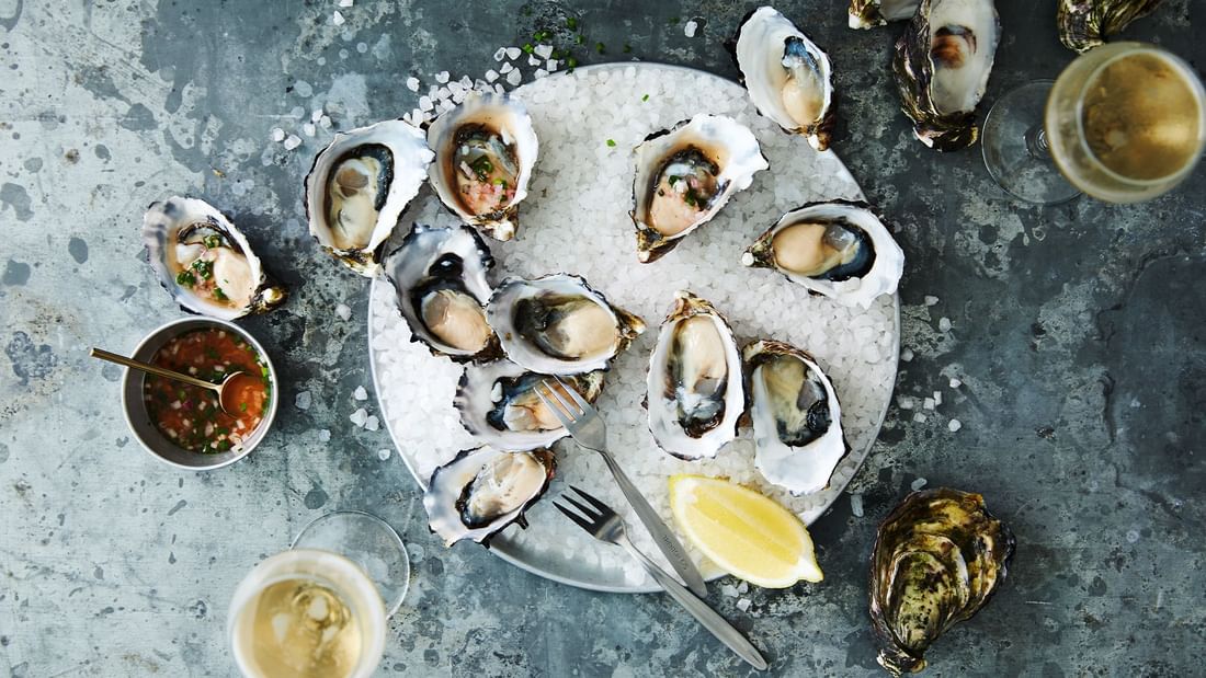 Freshly shucked oysters on ice with sauce, an elegant appetizer at Steak & Oyster Co. by Sean Connolly in Novotel Sydney