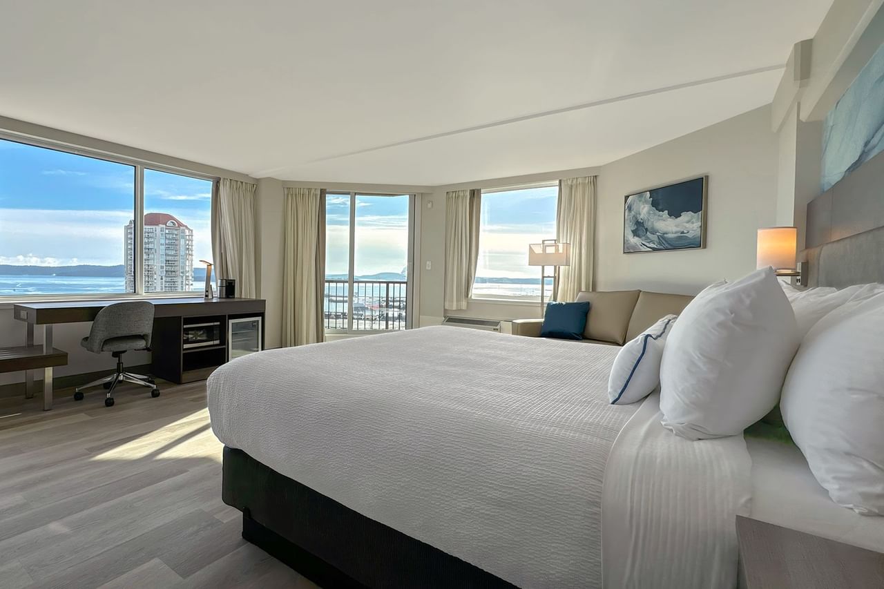 Hotel guestroom with King bed and a work desk with chair