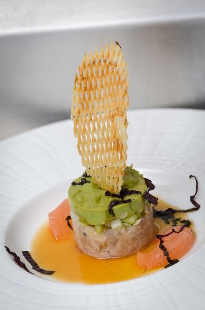 Avocado tartare elegantly presented with fresh garnish and accompaniments at The Stanley Hotel