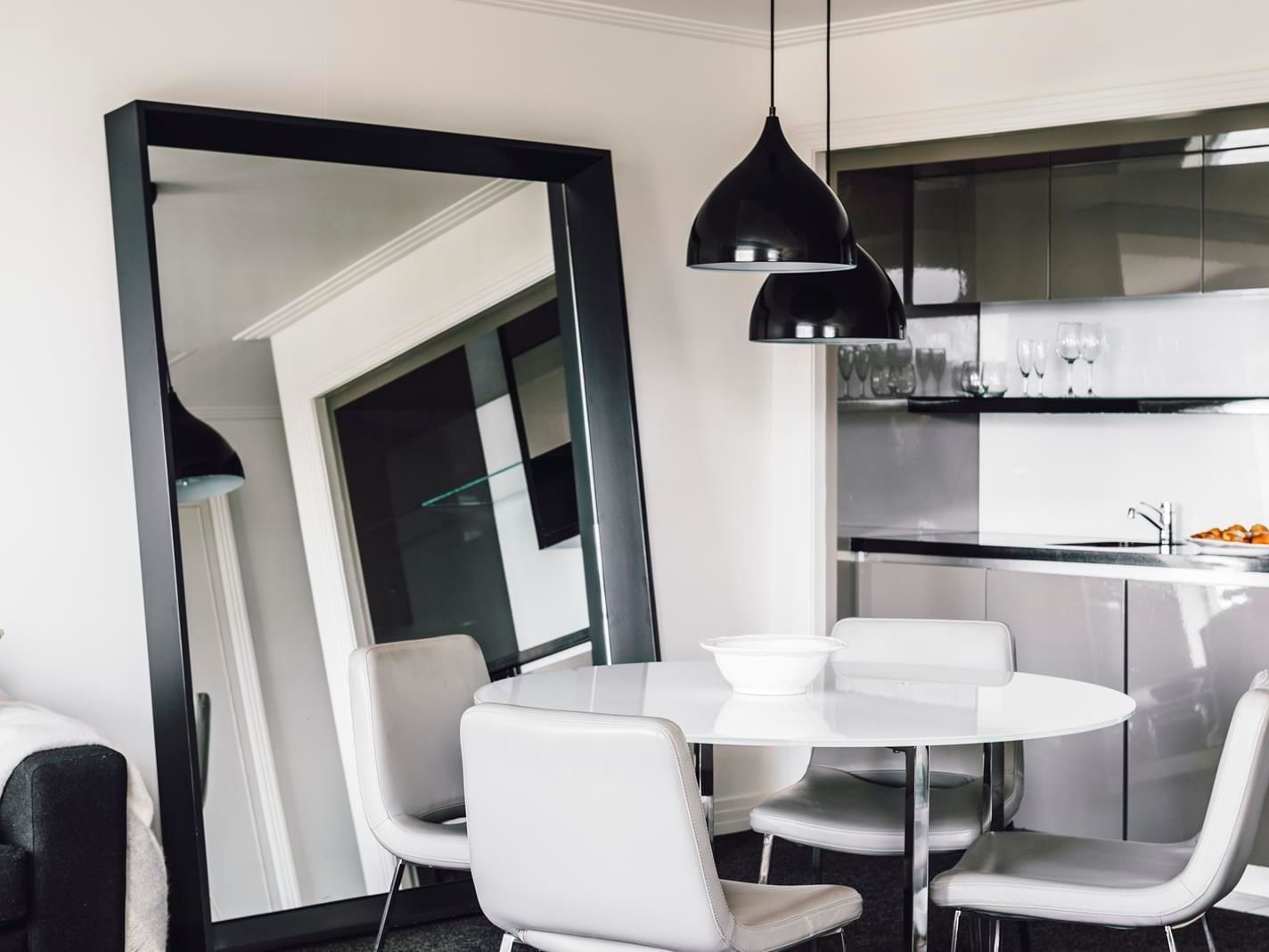 Dining table & large mirror in Junior Suite at Como Melbourne