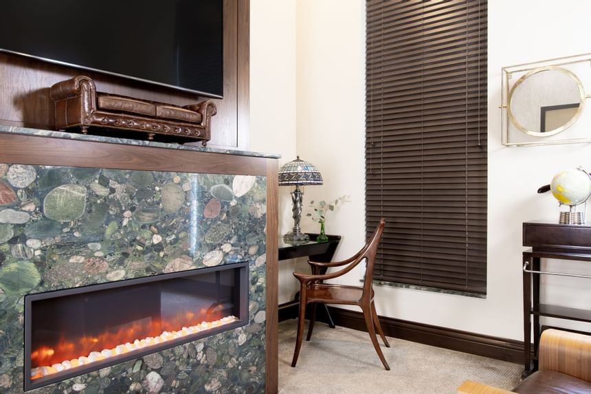 Marble fireplace, TV & work desk in King Premiere Library at Retro Suites Hotel