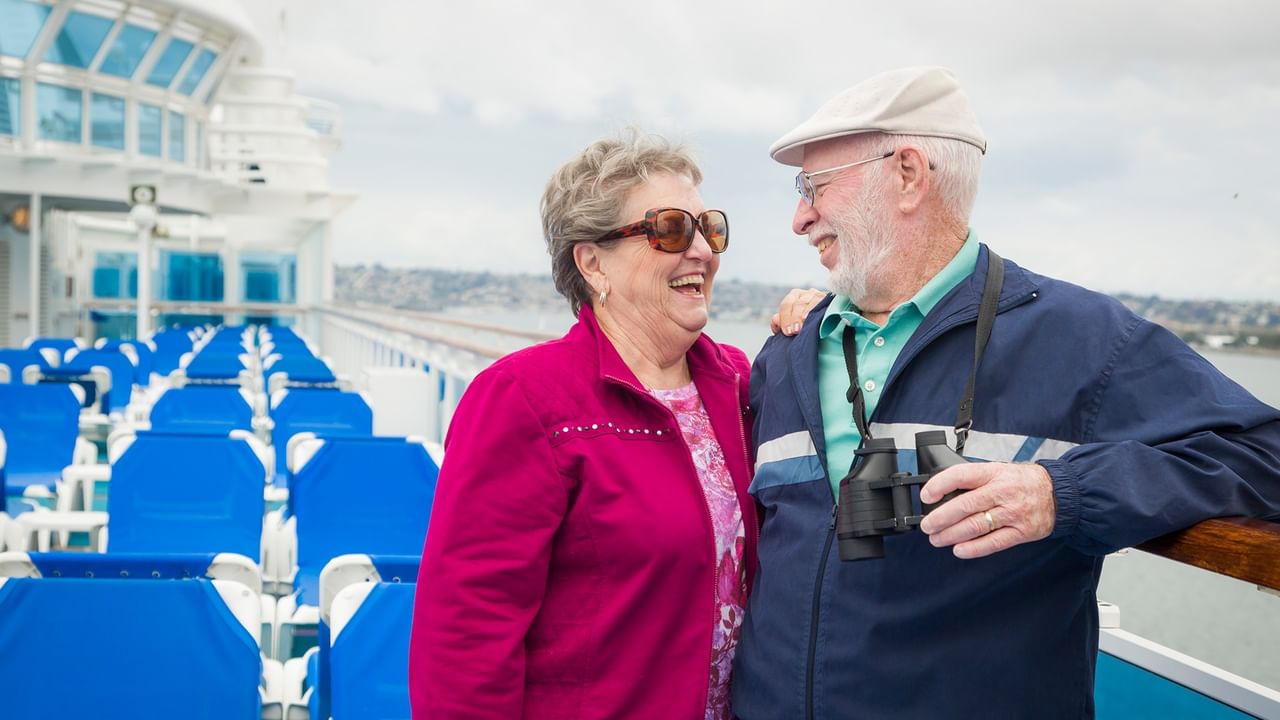 elderly couple on a cruise ship deck.