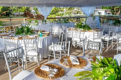 White-themed banquet tables arranged for a wedding at Bougainvillea Barbados