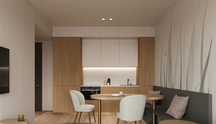 Kitchenette with wooden cabinetry and dining area in Suite Junior - Family with balcony at Hotel des Innovations