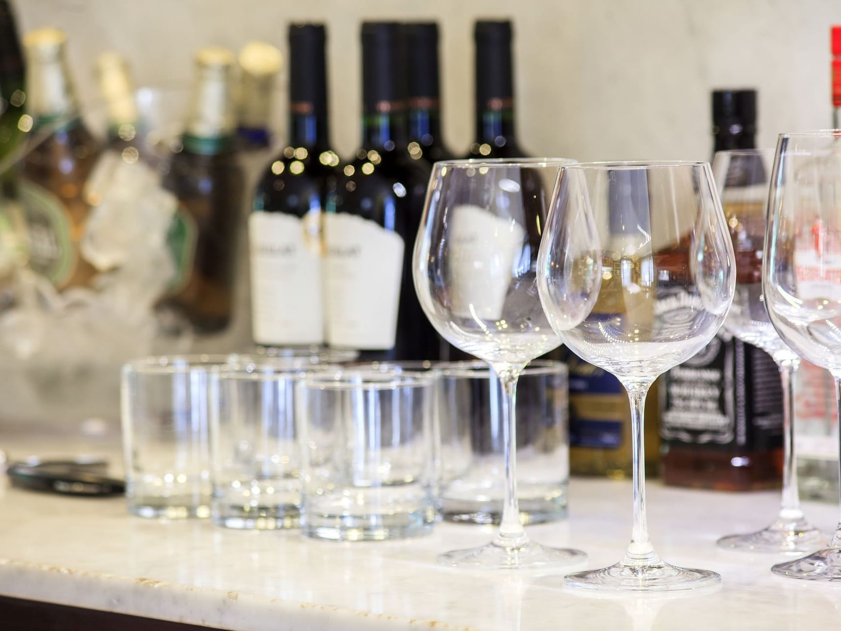 Wine glasses & bottles on a table, Boutique Le Reve Honesty Bar