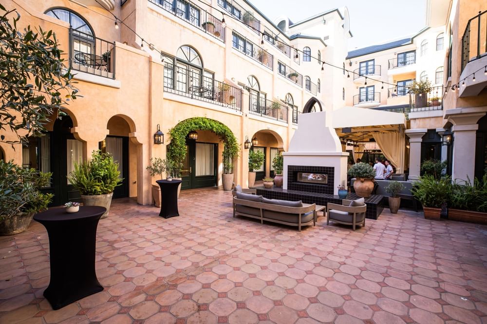 a wide angle shot of the courtyard at el PRADO, showcasing the fireplace in the center