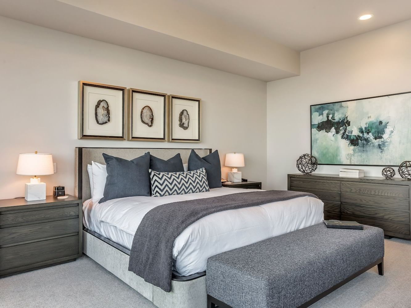 Cozy bedroom featuring a king bed with wall art in Premium Room at Stein Eriksen Residences