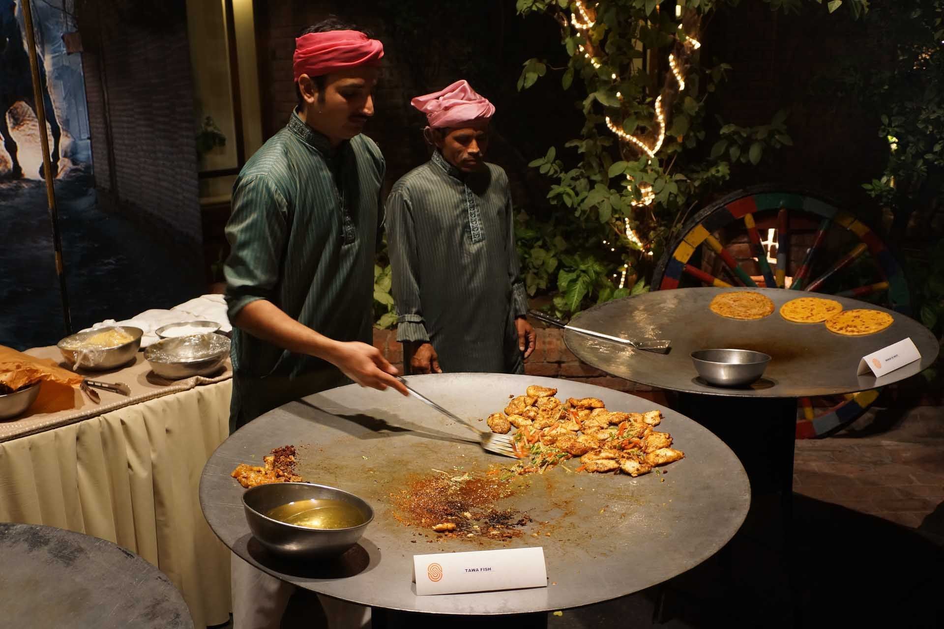 Chefs preparing a meal in Xuelian at Faisalabad Serena Hotel