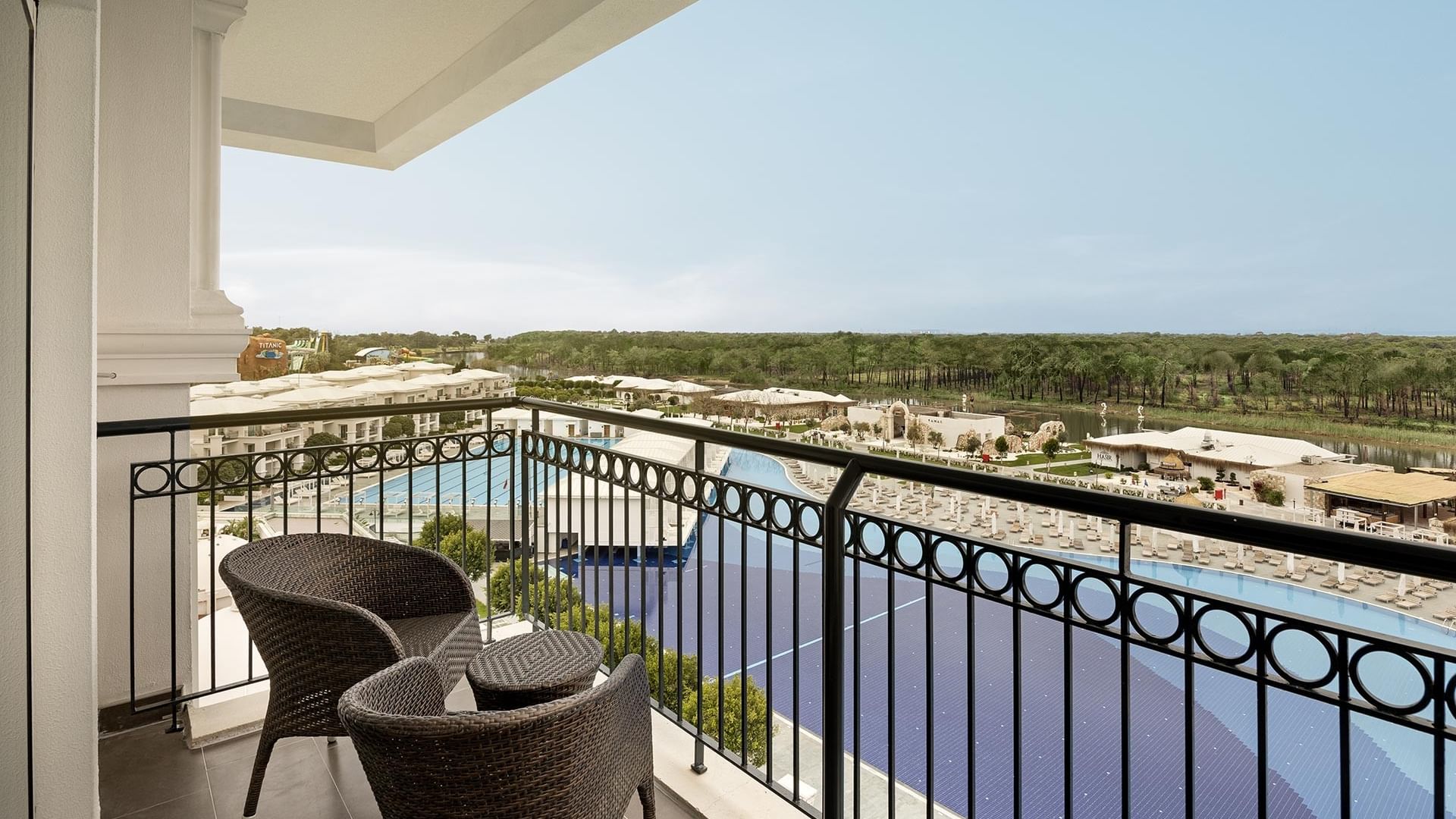 Balcony view of pool and resort from Corner Suite at Titanic Deluxe Golf Belek, Antalya.