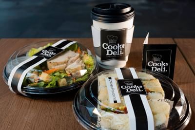Fresh chicken salad, sandwich, and coffee on a wooden table at Cooks Deli, The Saujana Hotel Kuala Lumpur