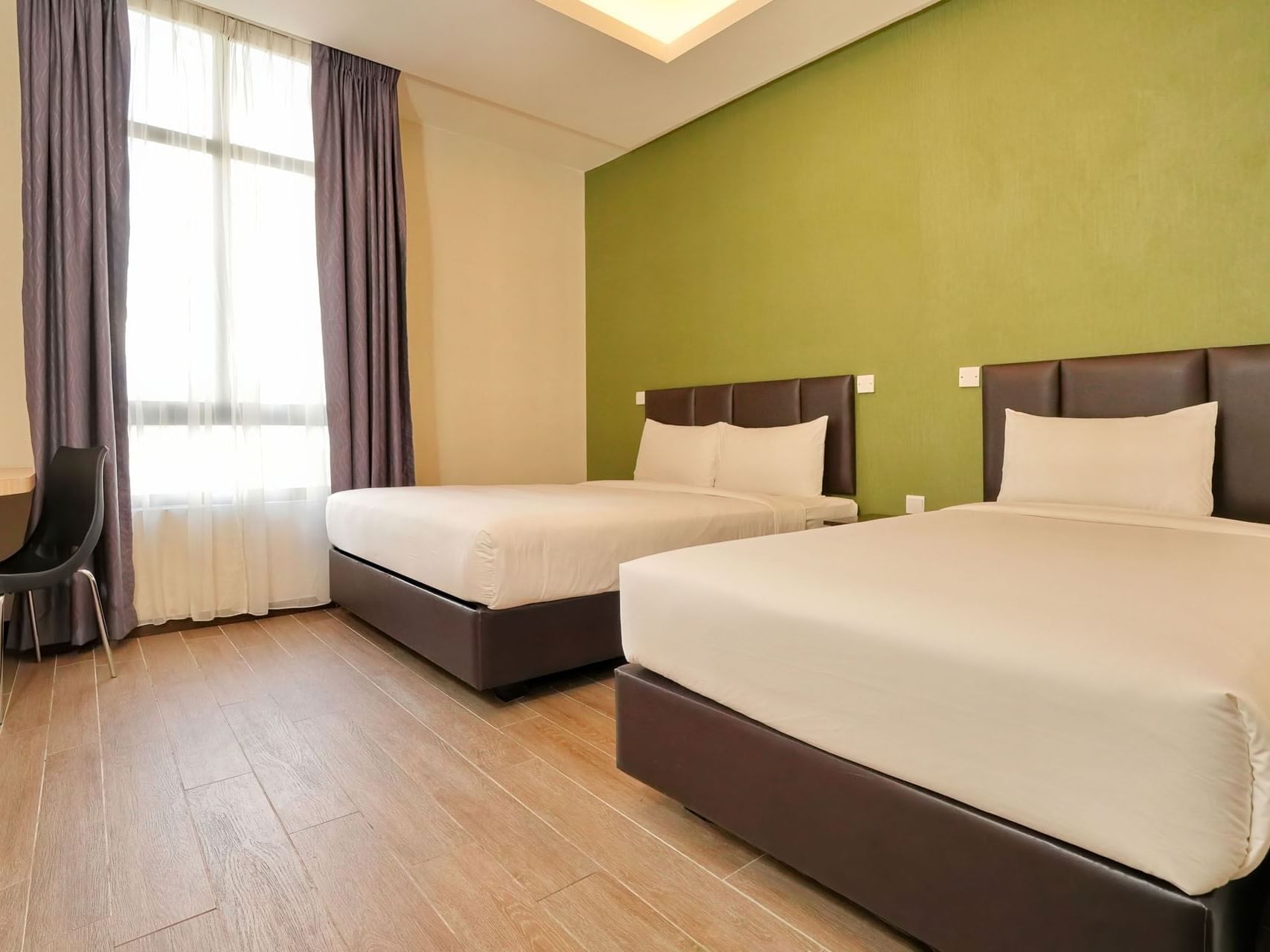 Superior Triple Room with wooden floors & white bedding at Cititel Express Ipoh