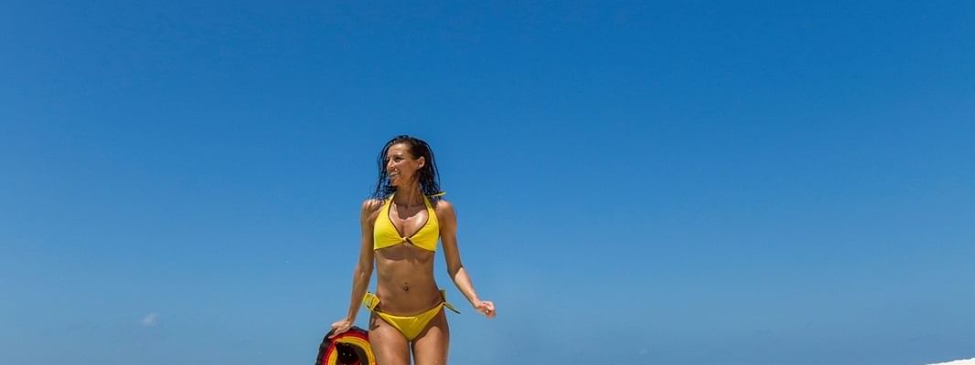 A lady enjoying her day at the beach near Crown Towers Sydney