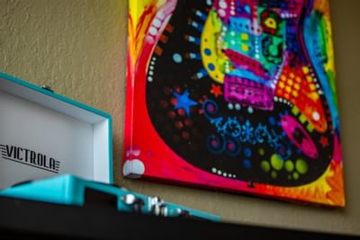 a painting of a guitar above a record player