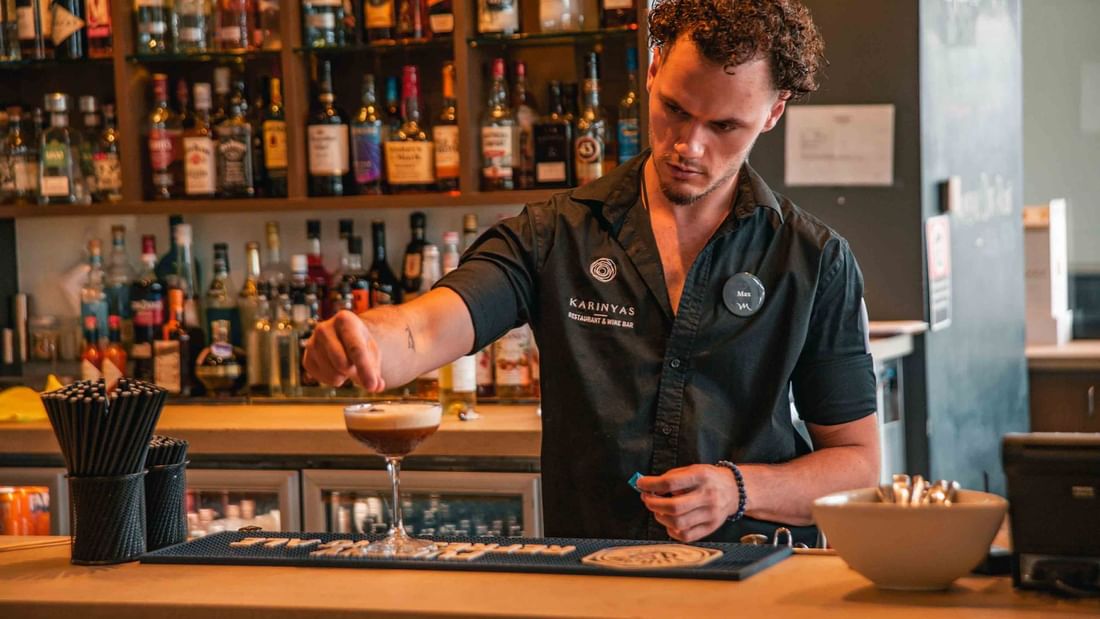 Bartender making cocktail at wine bar