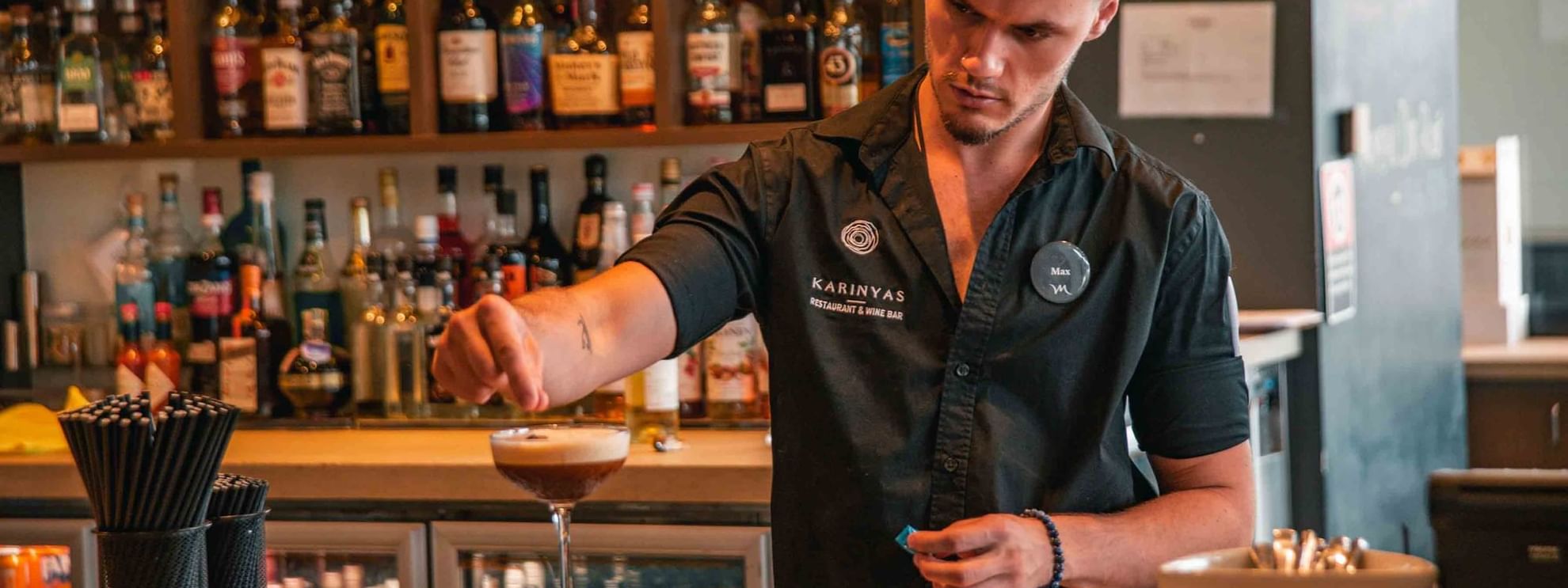 Bartender making cocktail at wine bar