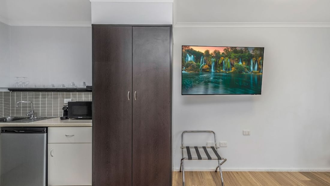 The Deluxe King Room features a sink, microwave, Nespresso coffee machine and a bar fridge