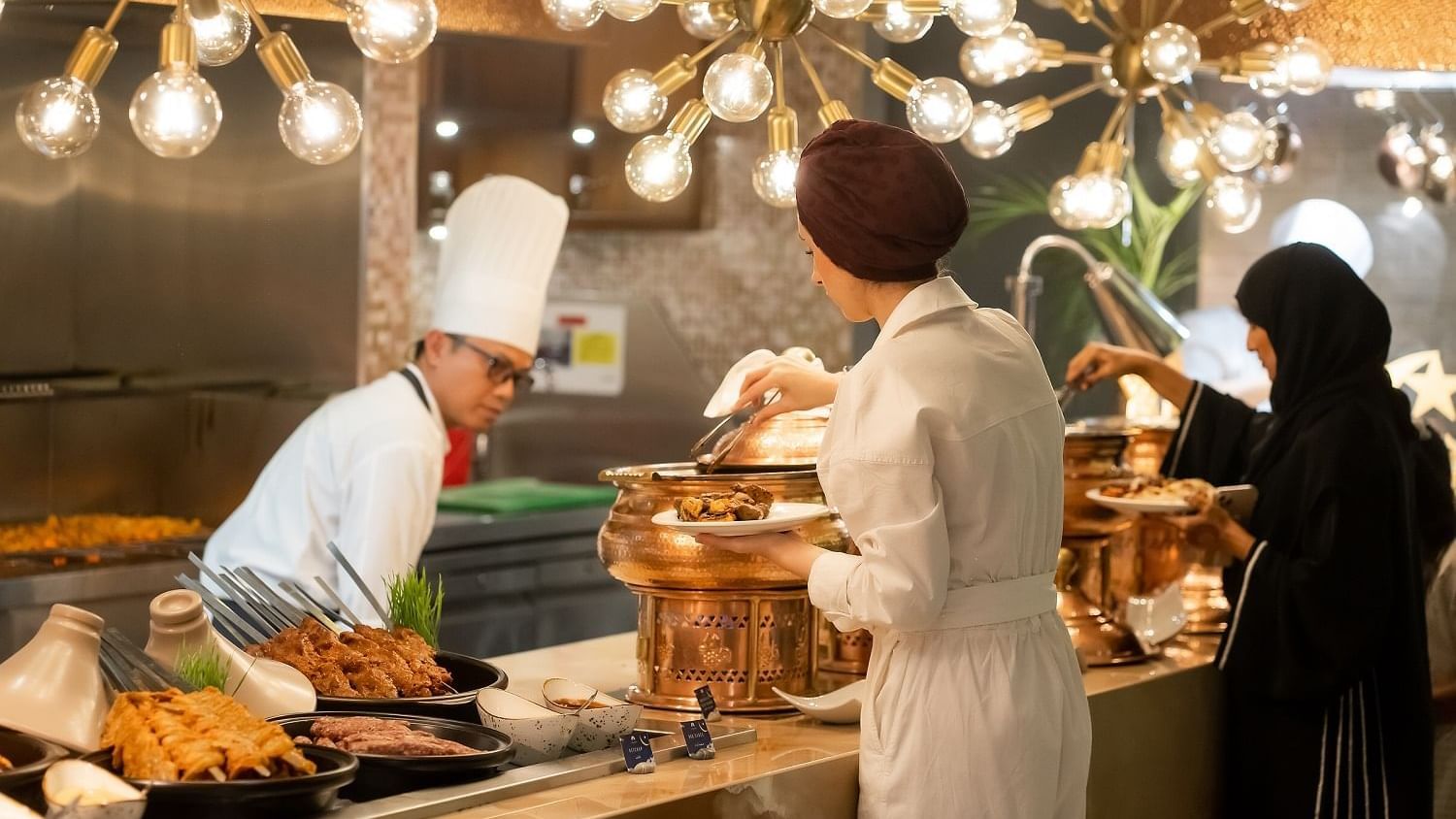 People getting food from the buffet in The Stage Restaurant at Paramount Hotel Dubai