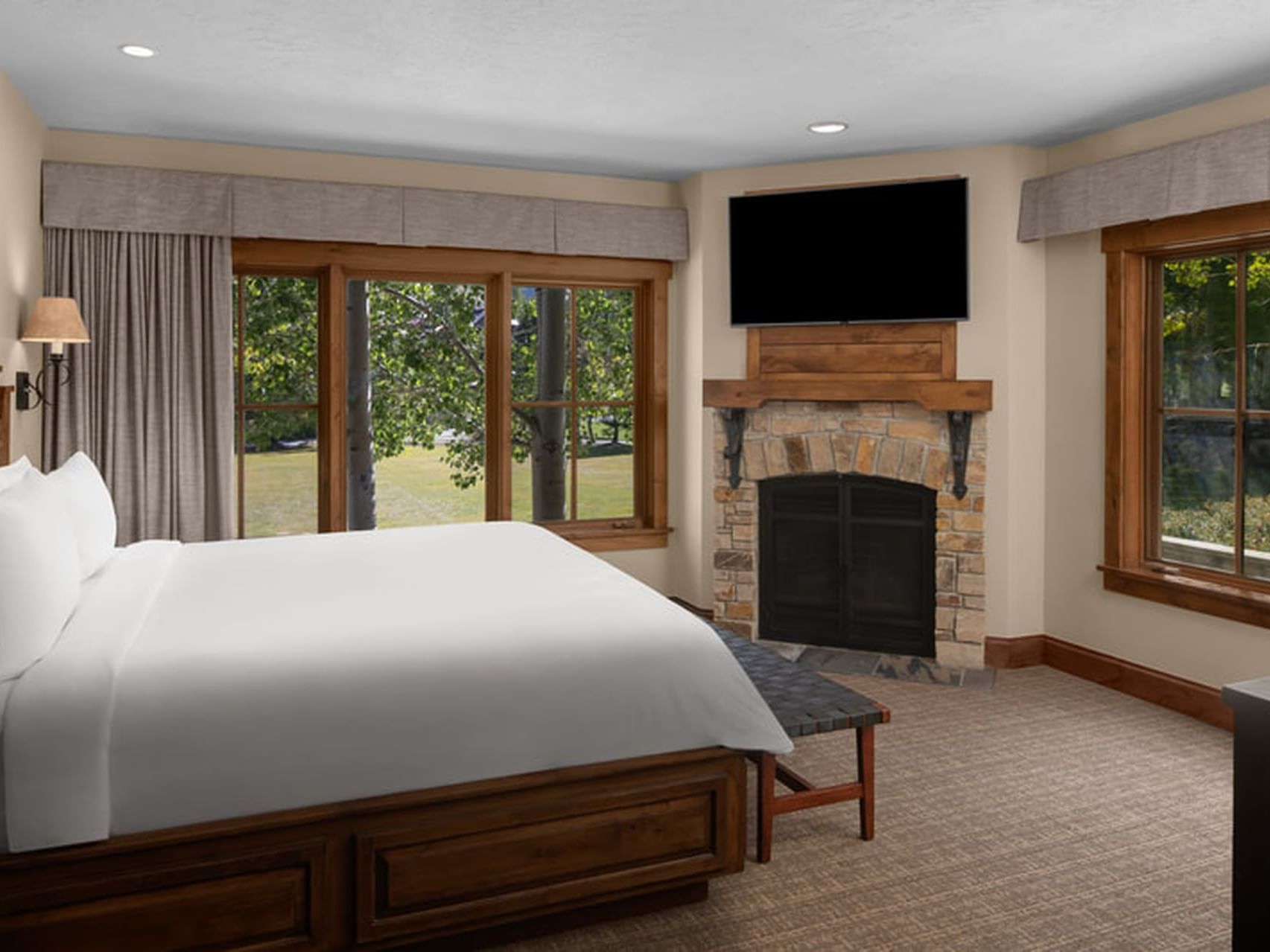 TV & fireplace facing the cozy bed in Presidential & Penthouse Suites at Hotel Park City Autograph Collection