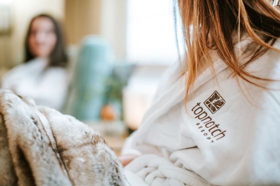 Two women wearing robes at the Spa in Topnotch Stowe Resort