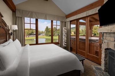 TV facing the bed near windows with a pond view in Cottage Deluxe Executive Suites at Hotel Park City Autograph Collection