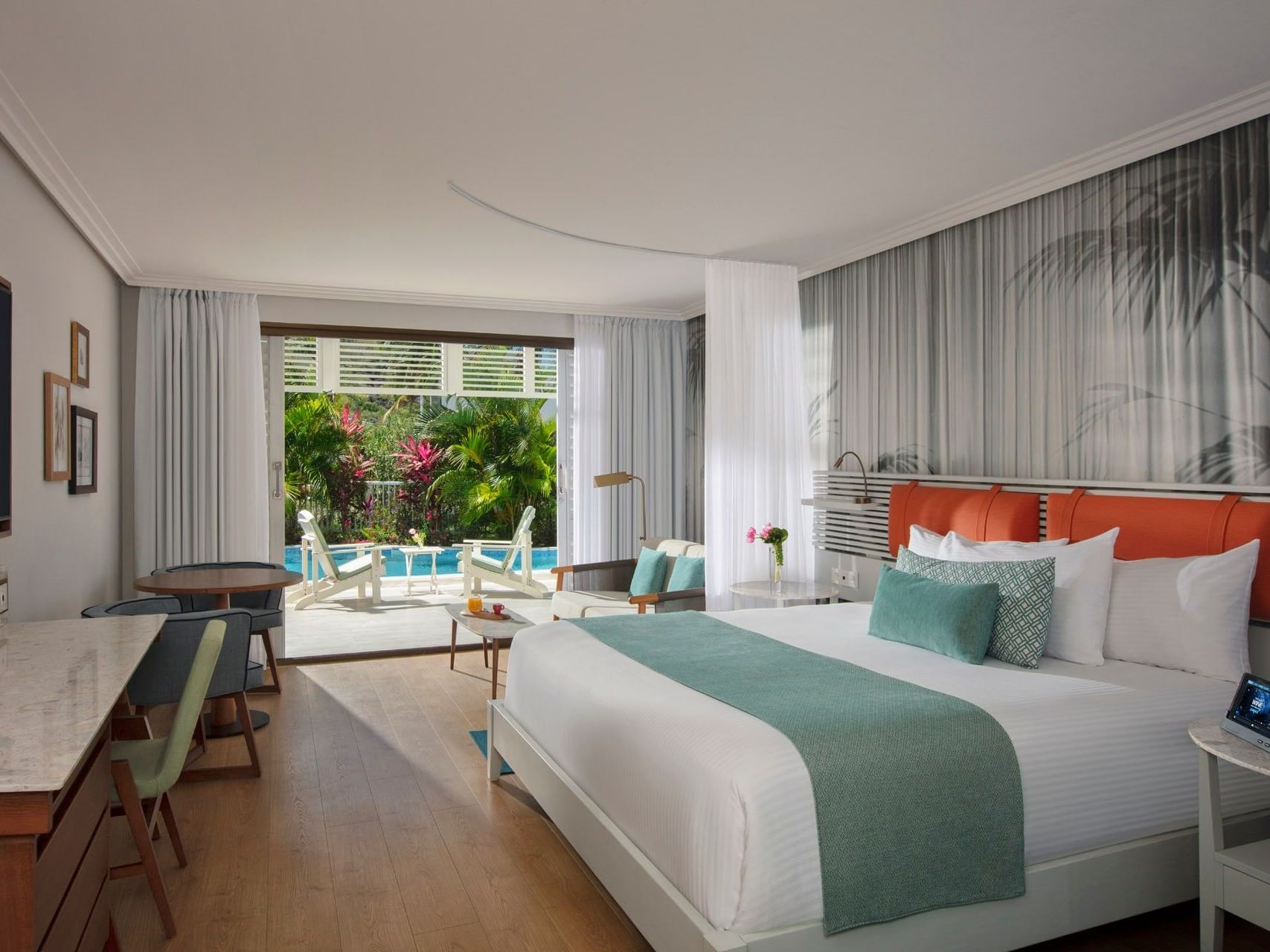 Workspace & cozy seating area by the cozy bed in King Bed Suite with Swim-Out Pool Access at Saint Martin Beach Resort & Spa