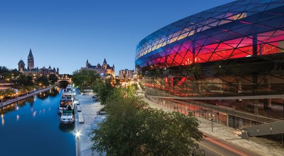 A vibrant cityscape with a Rogers Centre beside a calm canal near ReStays Ottawa