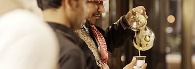 Close-up of a chef pouring tea at Narcissus Hotel & Spa Riyadh