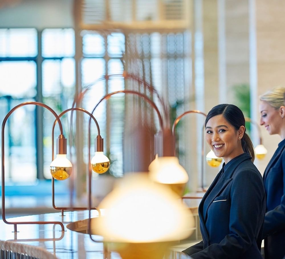 Two receptionists in the reception area at Crown Hotels