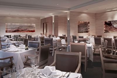 Dining table arrangements in a restaurant at Goodwood Hotel