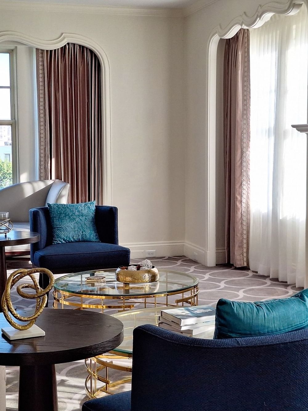 Elegant living room with fireplace and modern furniture in Presidential Suite at Warwick Melrose - Dallas.