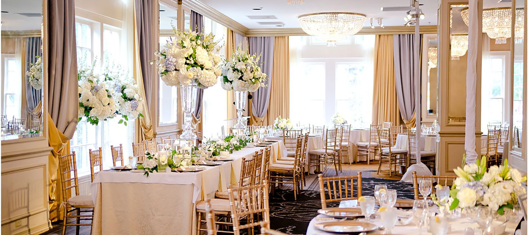 Floral table arrangements in a Hall for a wedding at Warwick Hotels and Resorts