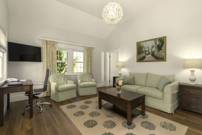 Living area arranged with the sofa and a TV at  Royal Palms Hotel