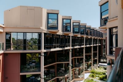 Modern Amora Herencia Riverwalk Melbourne, with multiple levels of outdoor balconies lined by large windows