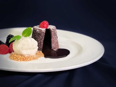 Chocolate lava cake with vanilla ice cream and fresh berries served in White Rose Cafe at York Hotel Singapore