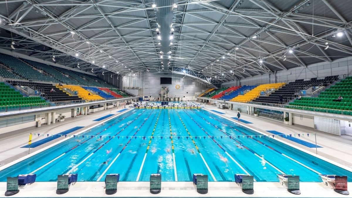 Interior view of the Sydney Aquatic Centre with a spacious pavilion near Pullman Sydney Olympic Park