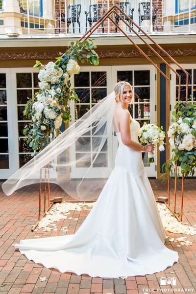 Bride posing by the altar at Horton Grand Hotel
