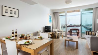 Dining area and living area in an apartment at Be Fremantle