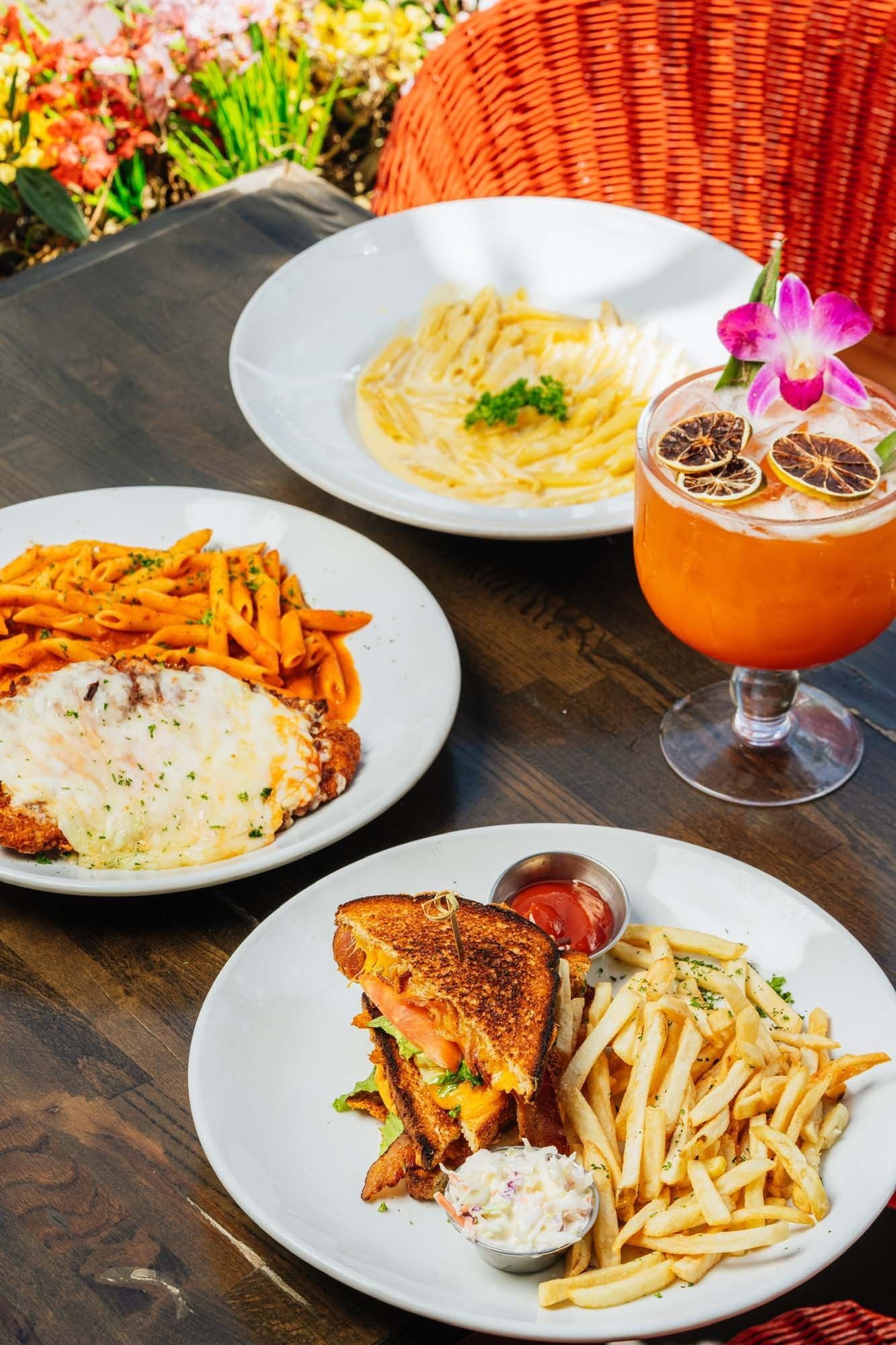 a table with three plates of food and a drink