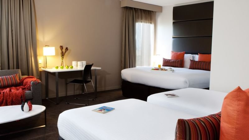 Family Room featuring two beds and a work desk at Novotel Sydney International Airport