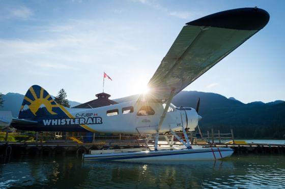 Whistler Air seaplane parked on a dock by the lake near Blackcomb Springs Suites