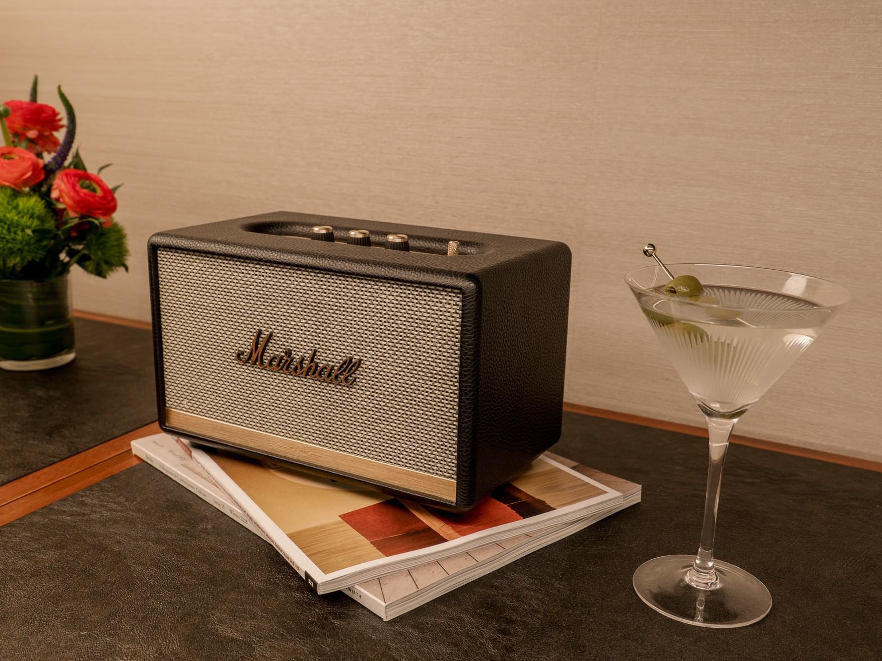 Marshall speaker and martini glass on table with flower vase in Two-Bedroom Manhattan Suite at Gansevoort Meatpacking NYC.