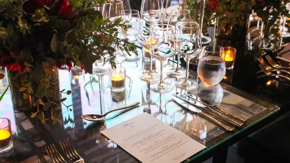 Table setting with stacked wine glasses and floating candles in Privé at Sofitel Brisbane Central