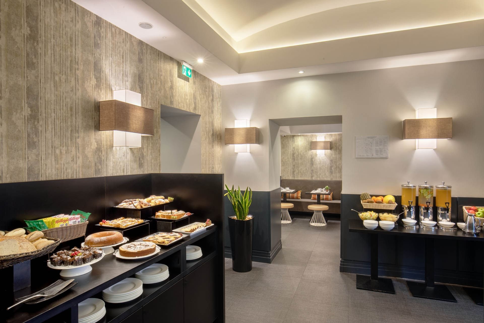Breakfast area featuring a buffet of pastries and beverages, with decor and seating arrangements at The Republic Hotel