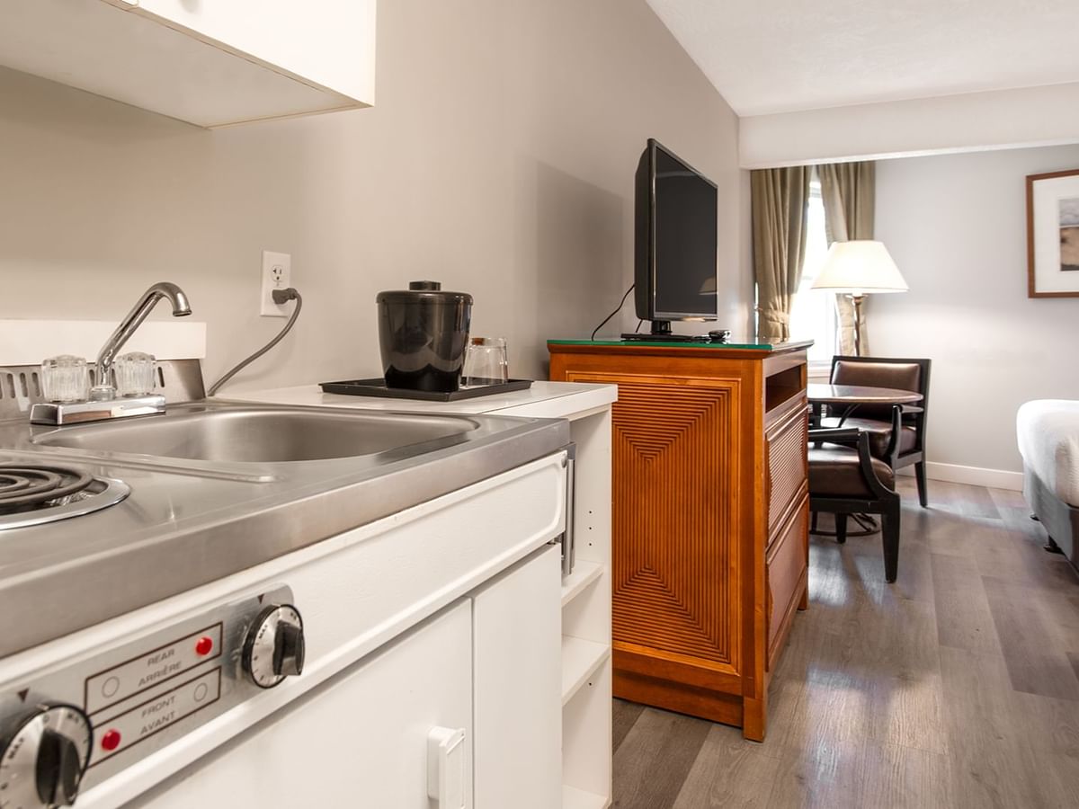 Hotel guestroom with two queen beds and a kitchenette