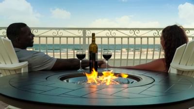couple drinking wine near firepit