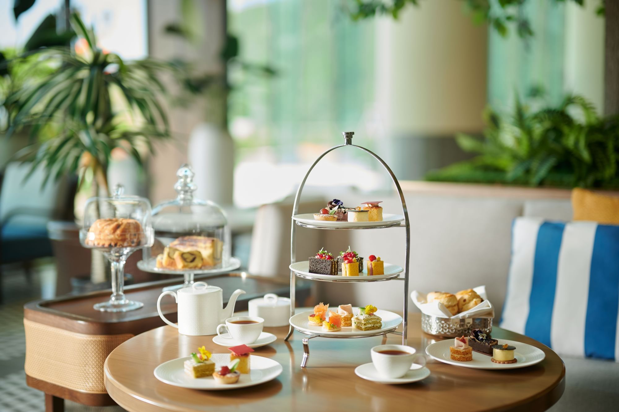 Afternoon Tea, with pastries on a tray over a grass-like surface by ferns, served at Fullerton Ocean Park Hotel Hong Kong 