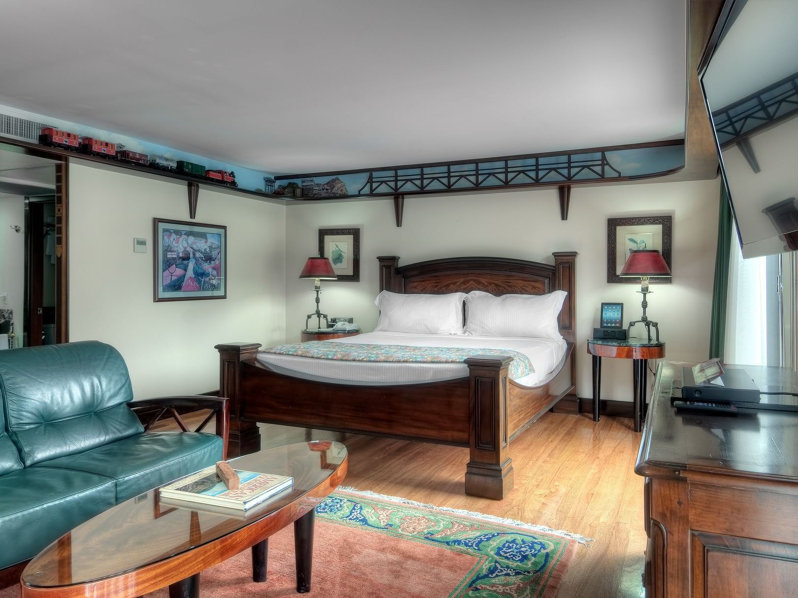 bedroom suite with blue couch and carpet