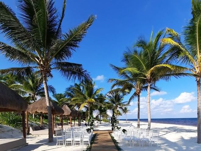 Sunloungers with canopies on the beach at Haven Riviera Cancun