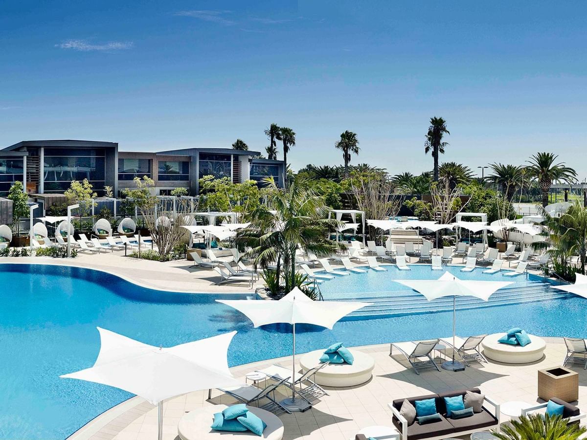 Pool area with sun loungers at Crown Metropol Perth